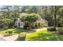 Beautiful two-story home with lush landscaping, mature trees, and a long driveway at 1420 Heritage Links Dr, Wake Forest, NC 27587