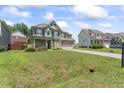Lovely front exterior showcases the home's architecture, landscaping, and spacious front yard at 1499 Fireside Ln, Creedmoor, NC 27522