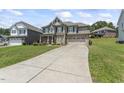 Attractive home featuring a long driveway and a well-maintained lawn, with lovely curb appeal at 1499 Fireside Ln, Creedmoor, NC 27522
