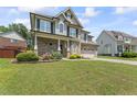 Beautiful exterior view of the two-story home with a well-kept lawn and mature landscaping at 1499 Fireside Ln, Creedmoor, NC 27522