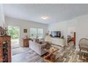 Bright living room offers wood floors, a comfortable sofa, and a door to the outside at 153 Bywood Dr, Roxboro, NC 27573