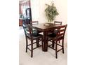 Cozy dining area featuring a dark wood table with four chairs and a lush potted tree at 1633 Snow Mass Way, Durham, NC 27713