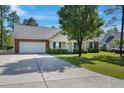 Charming single-story home with manicured lawn, long drive and attached two car garage at 169 Clearwater Harbor Hbr, Sanford, NC 27332
