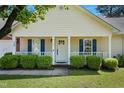 Home's inviting front porch with green shrubs, bright white railings and front door at 169 Clearwater Harbor Hbr, Sanford, NC 27332
