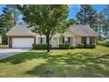 Charming single-story home with manicured lawn, inviting entrance and attached two car garage at 169 Clearwater Harbor Hbr, Sanford, NC 27332