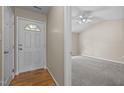 Inviting foyer leading to a carpeted room with a ceiling fan and ample natural light at 1728 E Honey Springs Ave, Fuquay Varina, NC 27526
