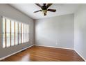 Bright and airy bedroom with hardwood floors, a ceiling fan, and a window with wooden blinds at 18 Gwendolyn Cir, Durham, NC 27703
