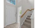 Inviting foyer featuring tiled floors, stairs, and decorative window above the front door at 205 Town Creek Dr, Cary, NC 27519