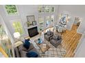 Bright living room with fireplace, vaulted ceilings, multiple windows, and hardwood floors at 205 Town Creek Dr, Cary, NC 27519