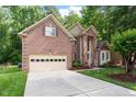 Beautiful two-story brick home featuring an attached two car garage and a spacious driveway at 216 Lewey Brook Dr, Cary, NC 27519