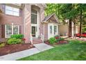Two-story brick home featuring a manicured lawn and an inviting entryway with steps at 216 Lewey Brook Dr, Cary, NC 27519