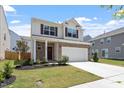 Attractive two-story home with a well-kept lawn, brick accents, and a convenient two-car garage at 2208 Seneca Dr, Raleigh, NC 27604