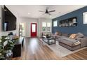 Stylish living room with hardwood floors, a comfortable gray couch, and a striking accent wall at 224 Daniel Ridge Rd, Wendell, NC 27591