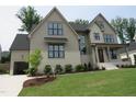 Charming two-story home with attached garage, fresh landscaping, and well-manicured lawn at 2577 Silas Peak Ln, Apex, NC 27523