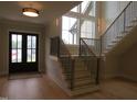 Bright foyer with wood floors, staircase and large windows at 2577 Silas Peak Ln, Apex, NC 27523