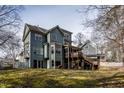 Spacious backyard featuring a deck, patio area, and mature trees, perfect for outdoor living at 2617 Charenson Pl, Raleigh, NC 27614