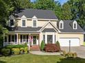 Charming two-story traditional home featuring a welcoming front porch and well-manicured lawn at 2645 Ridgewell Ct, Raleigh, NC 27613