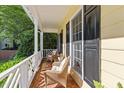 Cozy front porch featuring brick flooring and wicker seating, offering a relaxing outdoor space at 2645 Ridgewell Ct, Raleigh, NC 27613