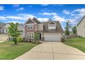 Charming two-story home featuring a spacious driveway and manicured front yard at 3413 Fairstone Rd, Wake Forest, NC 27587