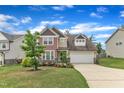 Charming two-story home featuring a spacious driveway and manicured front yard at 3413 Fairstone Rd, Wake Forest, NC 27587