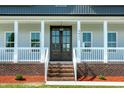 Charming covered front porch with a view of the beautiful lawn and landscaping at 3417 Aspen Rd, Rocky Mount, NC 27804