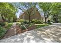 Brick home showcasing manicured lawn, brick walkway, and mature landscaping with a view of the driveway at 4109 City Of Oaks Wynd, Raleigh, NC 27612