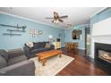 Bright living room with hardwood floors, ceiling fan, and cozy seating arrangement at 4114 Brenmar Ln, Durham, NC 27713