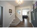 Inviting foyer featuring hardwood floors, stairs, and a view into the living area at 412 Ashdale Dr, Fuquay Varina, NC 27526