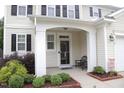 A welcoming front porch with a seating area and neat landscaping at 412 Ashdale Dr, Fuquay Varina, NC 27526