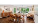 Bright living room and dining area with hardwood floors, large windows, and modern furnishings at 515 N Churton St # Ste 201, Hillsborough, NC 27278