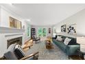 Inviting living room with fireplace, hardwood floors, stylish furnishings and backyard access through glass doors at 5315 Fortunes Ridge Dr, Durham, NC 27713