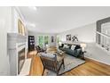 Bright and airy living room featuring hardwood floors, a fireplace, and stylish contemporary furniture at 5315 Fortunes Ridge Dr, Durham, NC 27713