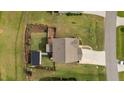Beautiful aerial view of a landscaped property with a manicured lawn and a charming home with a large driveway at 55 Prospectus Ln, Franklinton, NC 27525