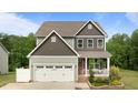 Charming two-story home with a landscaped front yard, covered porch, and attached two-car garage at 55 Prospectus Ln, Franklinton, NC 27525