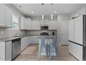 Bright kitchen features white cabinets, granite countertops, stainless steel appliances, and a center island at 55 Prospectus Ln, Franklinton, NC 27525