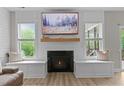 Living room showcasing a fireplace with a black surround and custom built-ins, plus modern decor at 55 Prospectus Ln, Franklinton, NC 27525