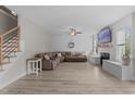 Spacious living room featuring modern flooring, a fireplace, a large sectional, and plenty of natural light at 55 Prospectus Ln, Franklinton, NC 27525