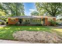 Traditional brick duplex with a shared front porch and green lawn at 603 Kildaire Farm Road Rd, Cary, NC 27511