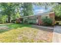 Inviting brick home with a lovely green lawn and mature trees at 603 Kildaire Farm Road Rd, Cary, NC 27511