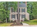Traditional two-story home boasting a timeless design, enhanced by mature trees and a neatly landscaped front yard at 608 Cross Timbers Dr, Durham, NC 27713