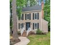 Inviting two-story home with a classic facade, highlighted by black shutters and a well-maintained front yard at 608 Cross Timbers Dr, Durham, NC 27713
