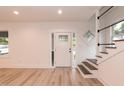 Bright foyer featuring new laminate flooring, and a staircase with iron railings at 612 Dunbar St, Durham, NC 27701