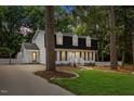 Two-story home with a well-manicured lawn and a white picket fence at 6709 Sunhaven Pl, Raleigh, NC 27615