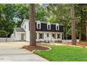 Charming two-story home with black roof, dormers, and a well-manicured lawn at 6709 Sunhaven Pl, Raleigh, NC 27615