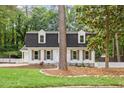 Charming two-story home with black roof, dormers, and a well-manicured lawn at 6709 Sunhaven Pl, Raleigh, NC 27615