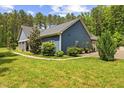 Side of the home with meticulous landscaping, lush green lawn, and elegant architectural details enhancing its curb appeal at 741 Sinai Cir, Hillsborough, NC 27278