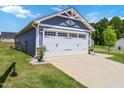 View of the garage and driveway area of this cute home, featuring a pristine concrete driveway at 75 Springwood Ln, Franklinton, NC 27525