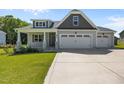 Charming home features a welcoming front porch and a convenient three-car garage at 834 Mamie Upchurch Rd, Lillington, NC 27546