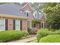 Charming brick home with manicured front yard and lush landscaping at 8605 Stanton Pl, Raleigh, NC 27615