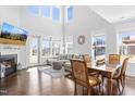 Bright living room featuring tall ceilings, a fireplace, many windows, and an open floor plan at 931 Haybeck Ln, Apex, NC 27523